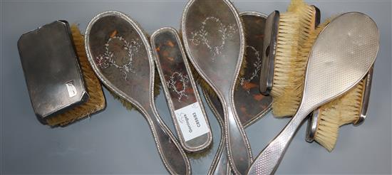 A silver and tortoiseshell dressing table set and six silver backed brushes (9)